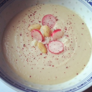 cauliflower and butterbean soup topped with pickled radish